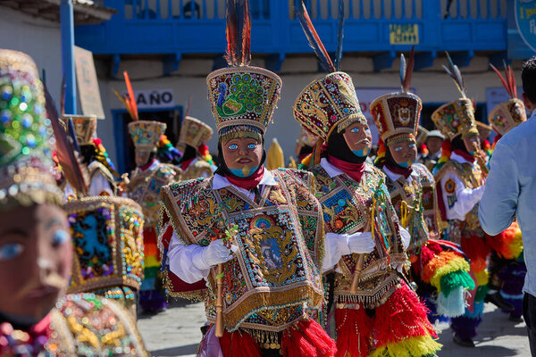 the Qhapaq Chunchu dancers of Paucartambo embody the Amazonian spirit during the Virgen del Carmen festivities. Their colorful costumes, feathered crowns, and striking masks reflect centuries of tradition, devotion, and cultural identity