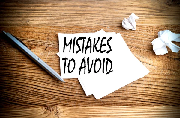 Ahşap arkaplanda yapışkan bir zemine yazılmış Hatalar AVID metnine