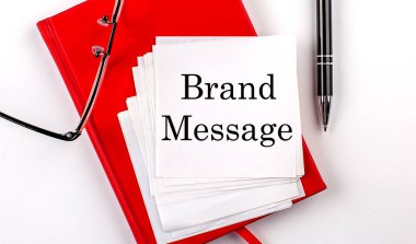 Kalem ve gözlüklü kırmızı defter üzerindeki bir çıkartma üzerindeki Brand MESAGE metni