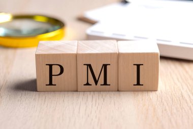 Tahta küplerde PMI, büyüteç ve hesap makinesi, finansal konsept arka planı.