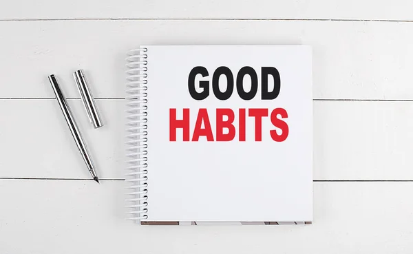 GOOD HABITS text written on a notebook on the wooden background