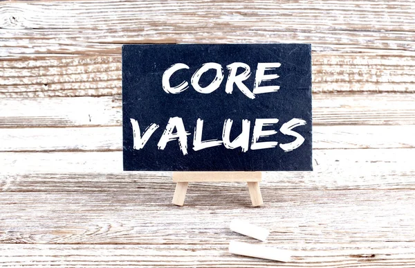 CORE VALUES text on Miniature chalkboard on wooden background