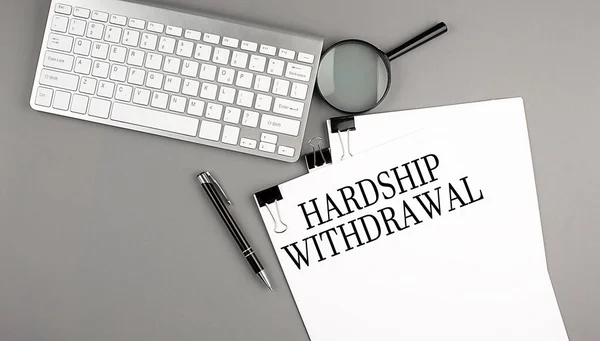 stock image Hardship Withdrawal text on paper with keyboard, magnifier and pen. Business