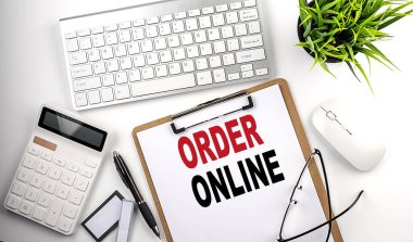 ORDER ONLINE text on a white paper. the inscription on the notebook