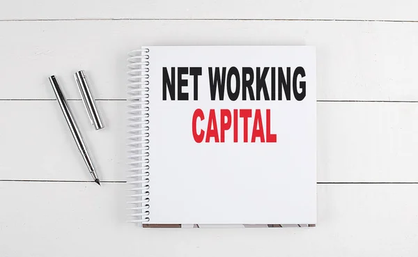 NET WORKING CAPITAL text written on a notebook on the wooden background