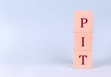 PIT on a wooden cubes on a blue background