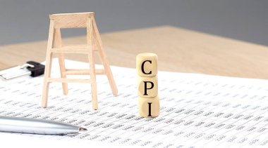 wooden cubes with the word CPI stand on financial background, business
