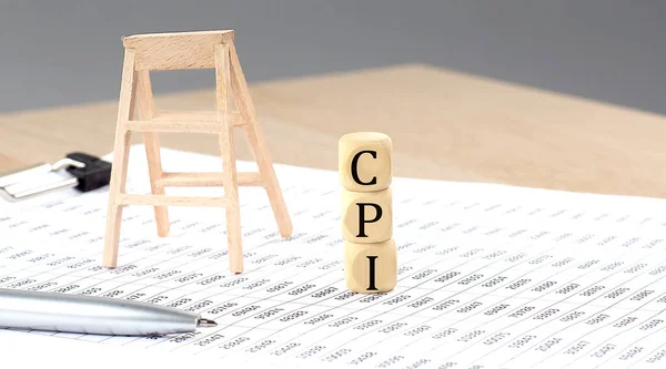 stock image wooden cubes with the word CPI stand on financial background, business