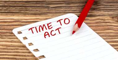 Word TIME TO ACT on paper with ped pencil on wooden background