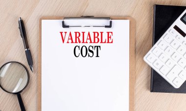 VARIABLE COST text on clipboard on wooden background