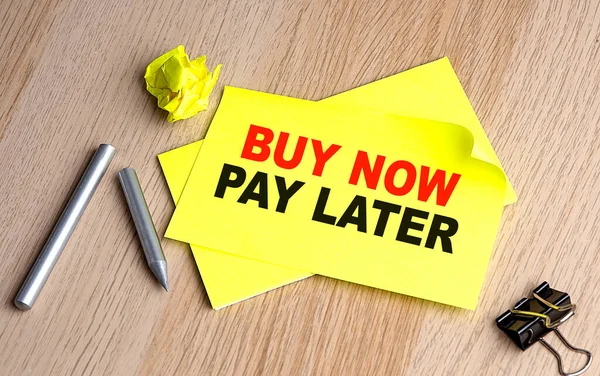 Buy Now Pay Later Text Yellow Sticky Wooden Background — Zdjęcie stockowe