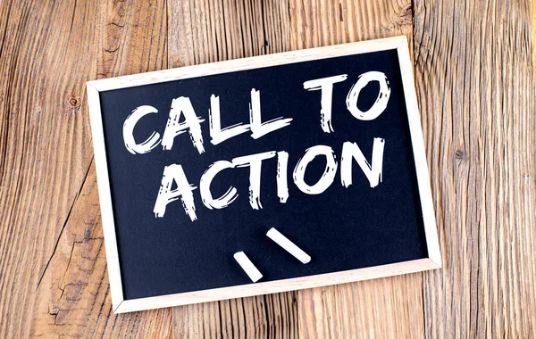 CALL TO ACTION text on chalkboard on the wooden background