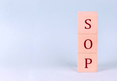 SOP on a wooden cubes on a blue background