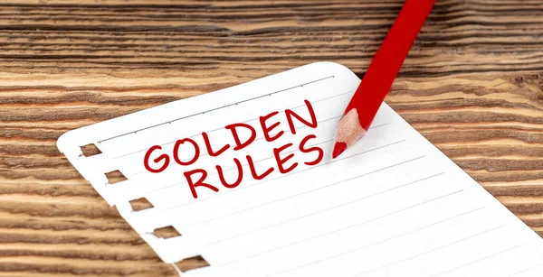 stock image Word GOLDEN RULES on paper with ped pencil on wooden background