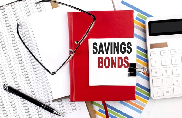 Saving Bonds Tekst Een Notitieboekje Met Grafiek Rekenmachine Pen — Stockfoto