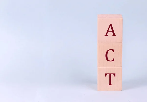 stock image ACT on wooden cubes on blue background