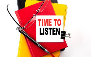 TIME TO LISTEN text written on sticky on colorful notebooks clipart