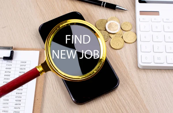 FIND NEW JOB text on magnifier with smartphone, calculator and coins