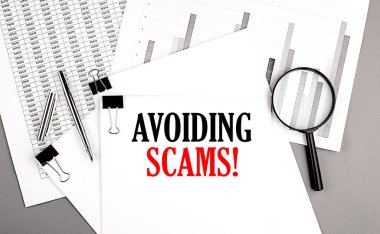 AVOIDING SCAMS text on paper on chart background clipart