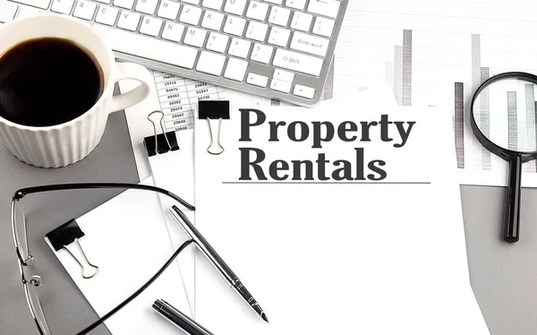 Property Rentals Text Paper Magnifier Coffee Keyboard Grey Background — Stock Photo, Image