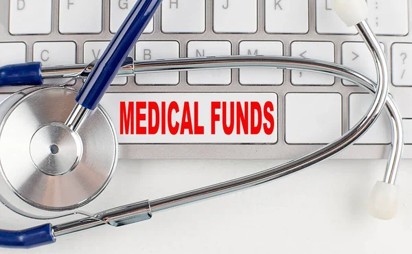 MEDICAL FUNDS text on a keyboard with stethoscope , medical concept
