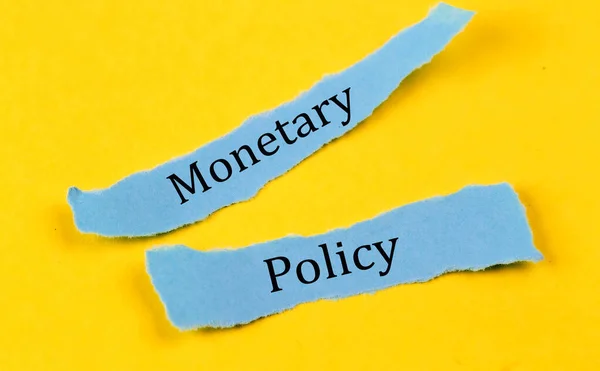 Monetary Policy Text Blue Pieces Paper Yellow Background Business Concept — Stockfoto