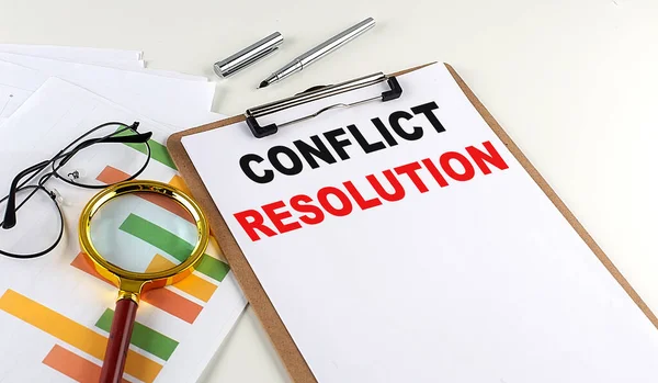 CONFLICT RESOLUTION text on a clipboard with chart on white background, business concept