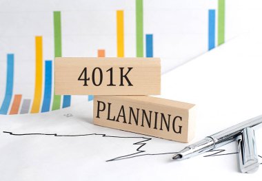 401 K PLANNING text on wooden block on chart background , business concept clipart