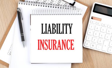 LIABILITY INSURANCE hesap makinesi, dosya ve kalem yanındaki beyaz not defterine yazılmıştır. İş konsepti