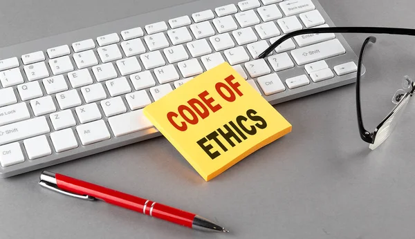 Code Ethics Text Sticky Keyboard Pen Glasses Grey Background — Stock Photo, Image