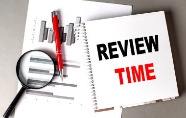 REVIEW TIME text written on a notebook with chart clipart