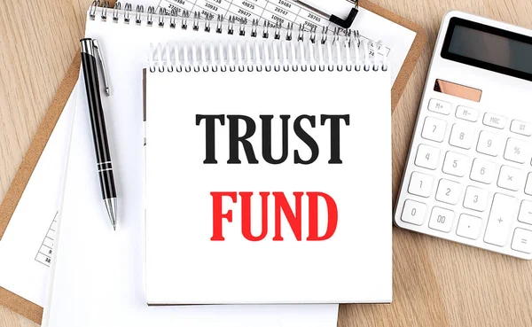 Доверие Fund Написано Белом Блокноте Возле Калькулятора Буфера Обмена Ручки — стоковое фото