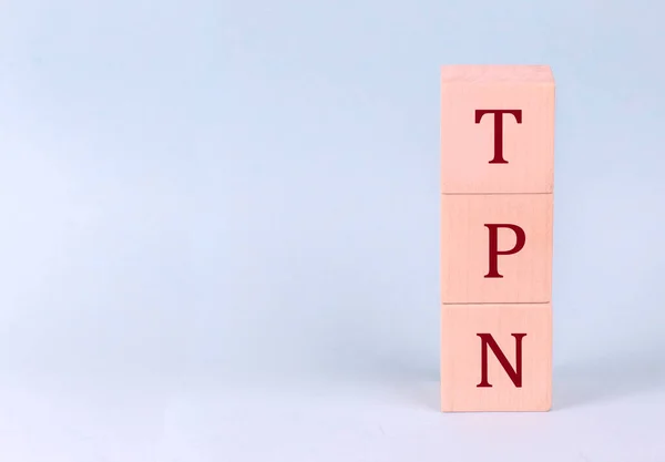 stock image TPN - Total Parenteral Nutrition on wooden cubes on blue background