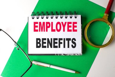 EMPLOYEE BENEFITS yeşil kağıt üzerinde bir defter üzerinde metin