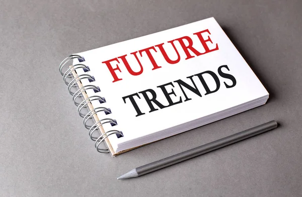 FUTURE TRENDS word on a notebook on grey background