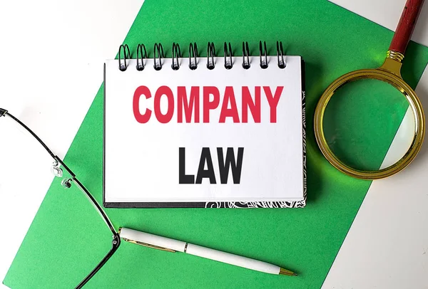 COMPANY LAW text on a notebook on green paper