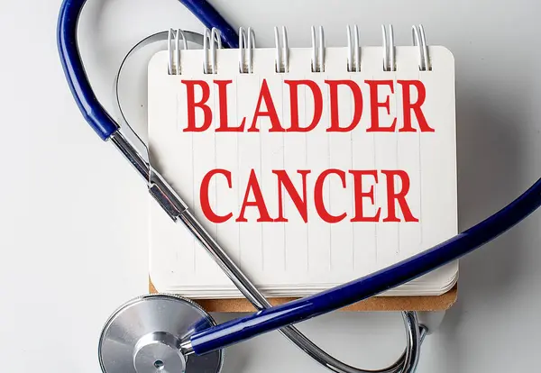 BLADDER CANCER word on a notebook with medical equipment on background