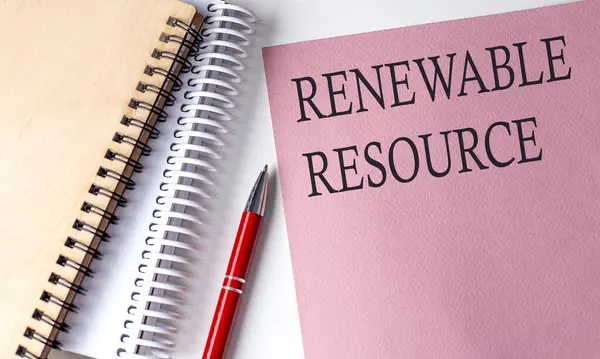 RENEWABLE RESOURCE word on pink paper with office tools on white background