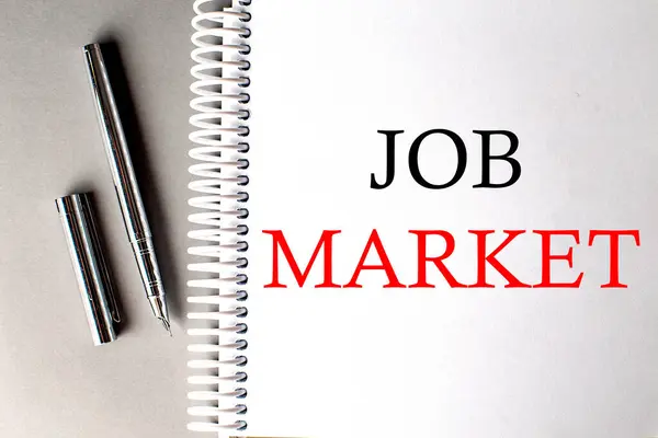 Job Market Text Notebook Pen Grey Background — Stock Photo, Image