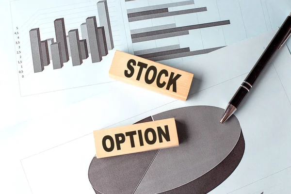 STOCK OPTION wooden block on a chart background