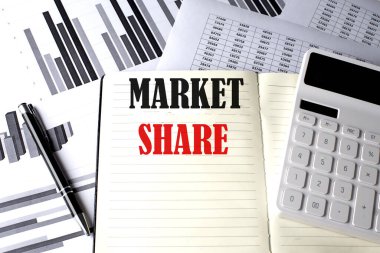 MARKET SHARE text written on notebook on chart and diagram clipart