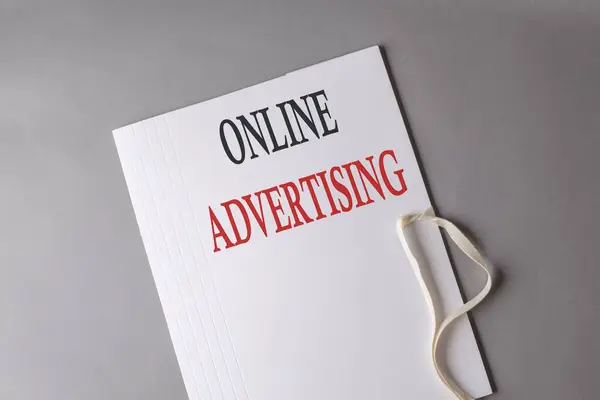 Online Advertising text on a white folder on grey background