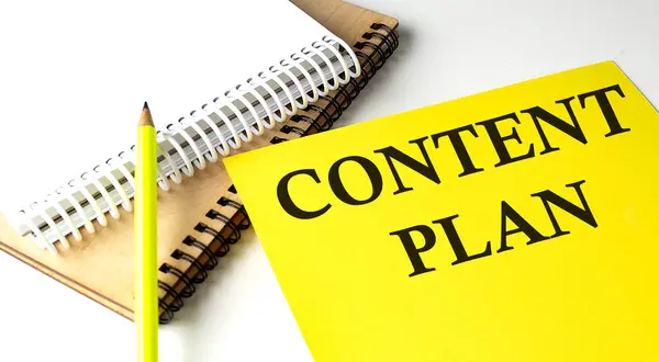 CONTENT PLAN text written on yellow paper with notebook