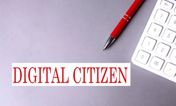 DIGITAL CITIZEN text written on gray background with pen and calculator