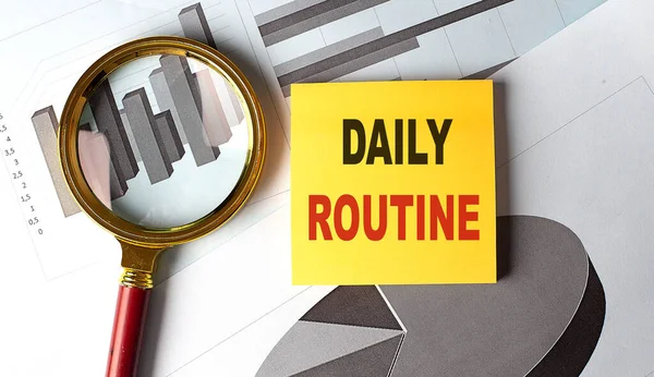DAILY ROUTINE text on a sticky on chart