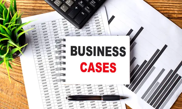 BUSINESS CASES text on notebook with chart and calculator