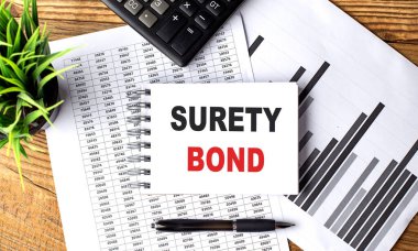 Not defterine çizelge ve hesap makineli SURETY BOND metni