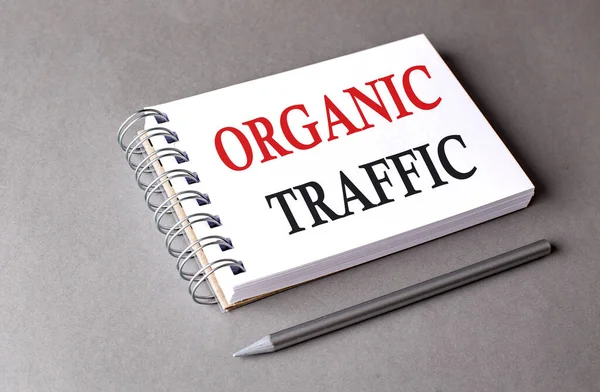ORGANIC TRAFFIC word on a notebook on grey background