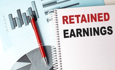 Not defterine çizelge arkaplanında kalemle ilgili EARNINGS metni