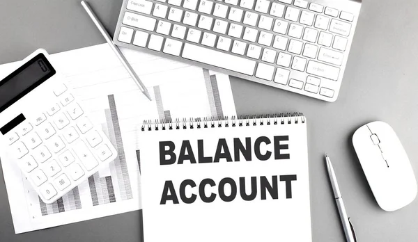 BALANCE ACCOUNT text on notebook with chart and keyboard business concept